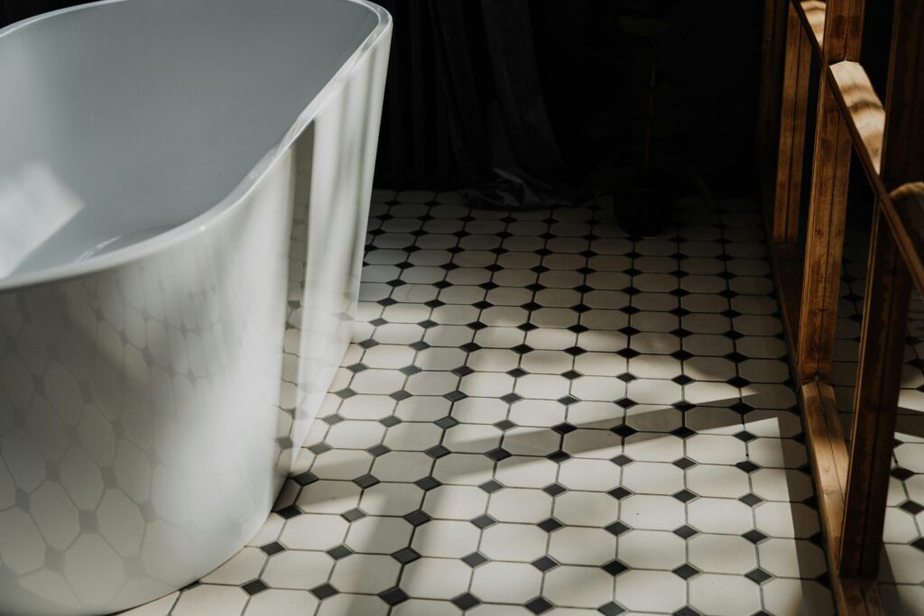 Minimalist bathroom with a freestanding tub and stylish hexagonal floor tiles, showcasing modern design.